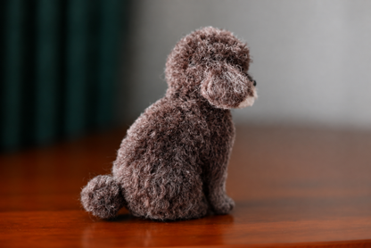 Side view of a handmade mini wool dog figurine